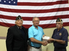 Mayor Philip Craighead presents a donation from the 7th Annual Charity Whip Crackin’ Rodeo to the American Legion Post 15.